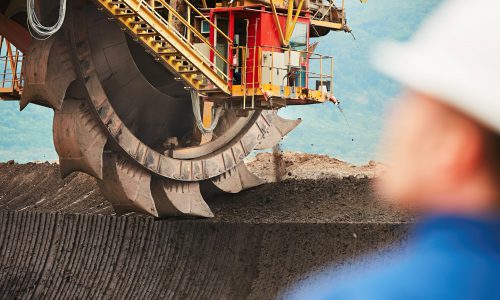 Coal mining in an open pit - Worker is looking on the huge excavator - industry in Czech Republic